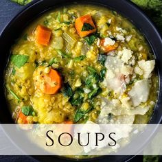 a black bowl filled with soup and vegetables