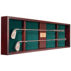 a display case with three golf clubs and two putty irons in it on a white background