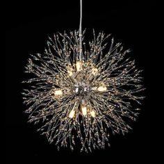 a chandelier hanging from the ceiling in a dark room with lights on it