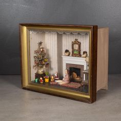 a miniature fireplace with figurines in it