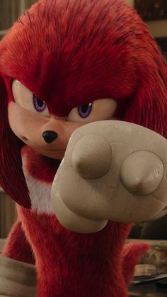 sonic the hedgehog from sonic the hedgehog is holding a toy in his right hand