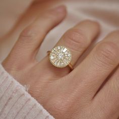 a woman's hand with a diamond ring on it