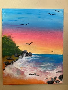 an acrylic painting of birds flying over the ocean at sunset or sunrise with rocks in foreground