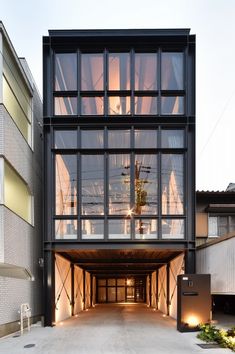 the entrance to an apartment building with glass walls