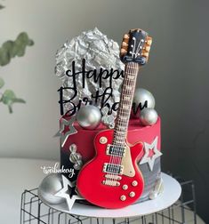 a birthday cake with a guitar on top