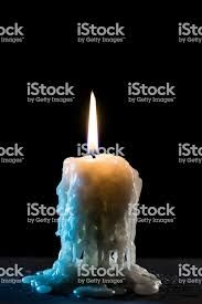 a lit candle with ice on the bottom and water around it stock photo, royalty - free