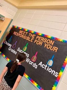 a girl standing in front of a sign that says meet the person responsible for your choice