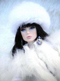 a doll wearing a white fur coat and earrings