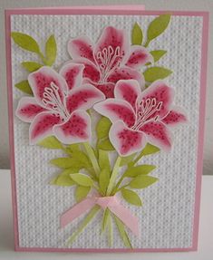 a card with pink flowers and green leaves