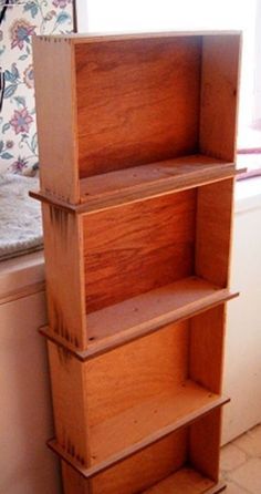 a wooden shelf sitting in front of a window