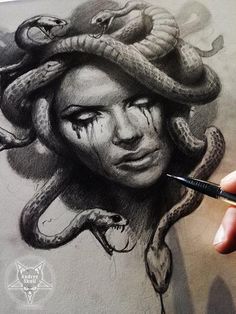 someone is drawing a woman's face with snakes on her head