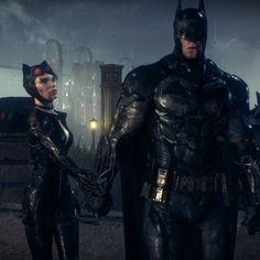 batman and catwoman standing next to each other