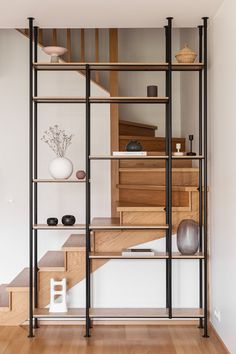 an open shelving unit with wooden steps and shelves