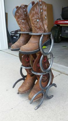 several pairs of cowboy boots are stacked on top of each other