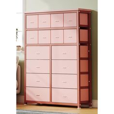 a pink dresser with drawers in a room