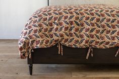 the bed is made up with a colorful comforter