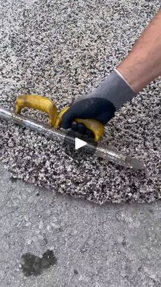 a man is using a pair of gloves to clean the pavement