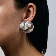 This earring is a 3 earrings in one! It is combination of Orbit double sided and Orbit geometrical earring. Back side works as a ear closure and can be worn with any other post earring. A truly one of the kind statement earring that speaks for itself. Can be worn combining front or back part, back side with any other post earring, only front side as Orbit geometrical earring. Will be handmade in limited quantity of 10 pairs. - Get as a pair or as a single statement earring. - Available in silver Luxury Single Earring In Contemporary Style, Modern Earrings Simple, Luxury Contemporary Jewelry With Unique Design, Luxury Minimalist Sphere Earrings, Elysian Theory Earrings, Modern Silver Ear Cuff, Modern Silver Single Wrap Earring, Modern White Gold Sterling Silver Wrap Earrings, Modern Sterling Silver Drop Wrap Earrings