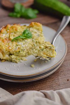 a piece of quiche on a plate with a fork