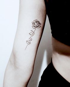 a woman with a rose tattoo on her arm