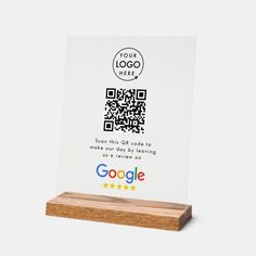 a wooden stand with a qr code on it and a google logo in the middle