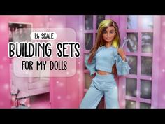 a barbie doll is standing in front of a pink wall with the words building sets for my dolls