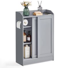 a gray cabinet with some bottles and soaps on the top shelf next to it