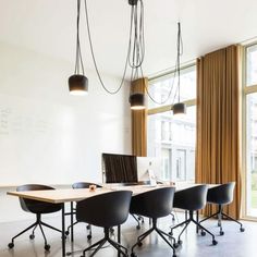 a conference room with black chairs and white walls