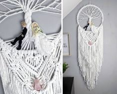 there is a white macrame hanging on the wall with two dolls in it