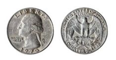 an old silver coin with the head of a man in profile, and two other coins behind it