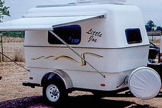 an rv parked on the side of a dirt road