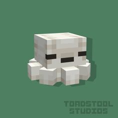 an image of a white cube with black eyes on it's face and the words toadstol studios in front of it