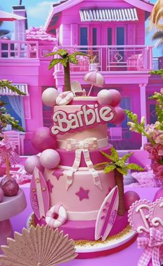 there is a pink cake that says barbie on it and palm trees in the background