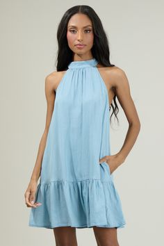 Make moves in the Laly Chambray Mini Ruffle Dress! It features a halter neck with a back tie, no sleeves, and a mini ruffle hem. Add on your favorite sandals or strappy heels to go along with this cute chic dress!- Halter- Back tie neck- Embroidered- Pockets- Color: Lt ChambraySize + Fit - Model is 5'8" and wearing size XS- Measurements taken from size S - Chest: 19"- Length: 31 1/2" Fabric Self:100% Cotton Style Number STD14089B Halter Neck Dress Outfit, Childrens Shop, Casual Date Night, Casual Date, Chambray Dress, Top Graphic Tees, Strappy Heels, Cotton Style, Chic Dress