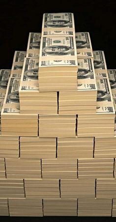 stacks of one hundred dollar bills sitting on top of each other in front of a black background