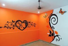 an orange room with black and white designs on the wall, butterflies flying around it