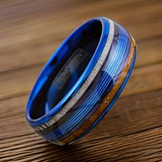 a blue ring with wood inlays on it