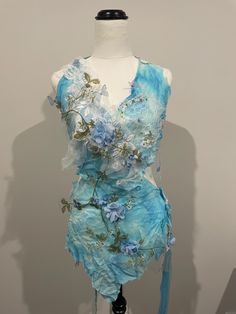 a mannequin with blue flowers on it's body