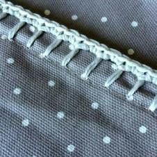 there is a piece of fabric that has been stitched together with white dots on it