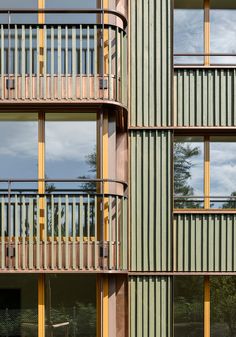 an apartment building with multiple balconies and wooden balconies on the sides