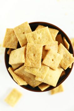 a bowl filled with crackers on top of a table