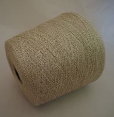 a spool of twine on a white surface