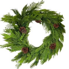 a green wreath with pine cones and needles