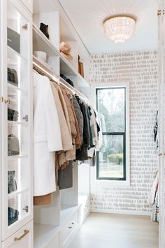 a walk in closet filled with lots of clothes