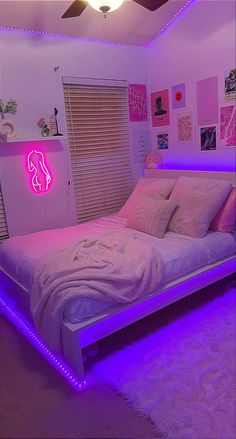 a bedroom with pink and purple lights on the ceiling, bed in front of window