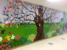 a colorful mural on the side of a building with trees and flowers painted on it