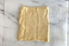 a piece of dough sitting on top of a white counter