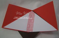 an open red and white card with a tie on it