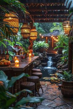 an outdoor dining area with candles and plants