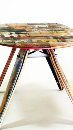 a multicolored wooden table sitting on top of a white floor